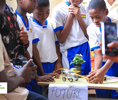 Children with a solar-powered model car