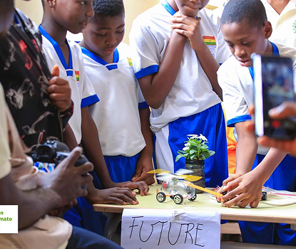 Children with a solar-powered model car